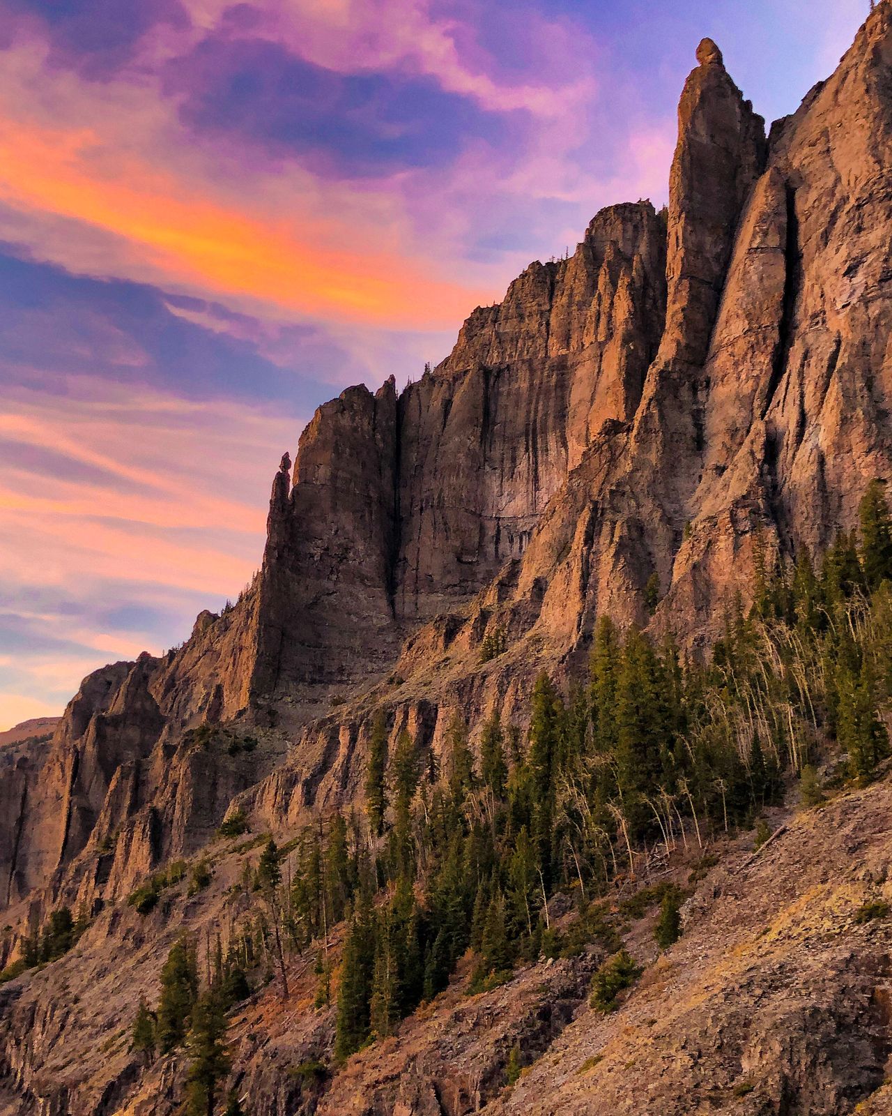 Red rock spires under a pink and orange sunset